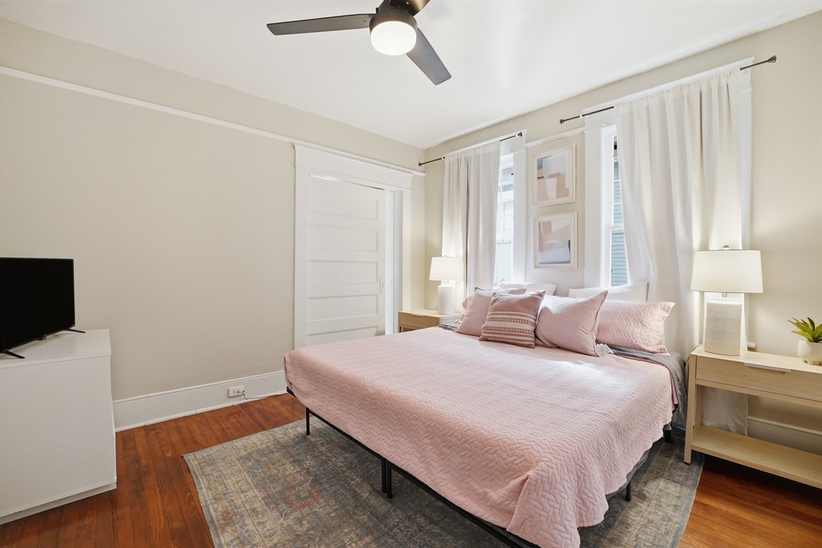 master bed room with king bed and TV