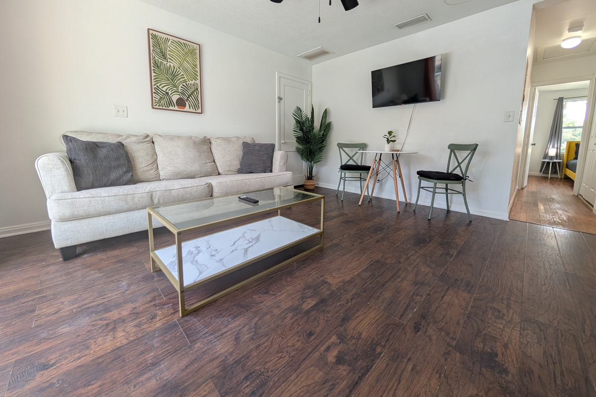Comfortable living room with smart TV and breakfast table