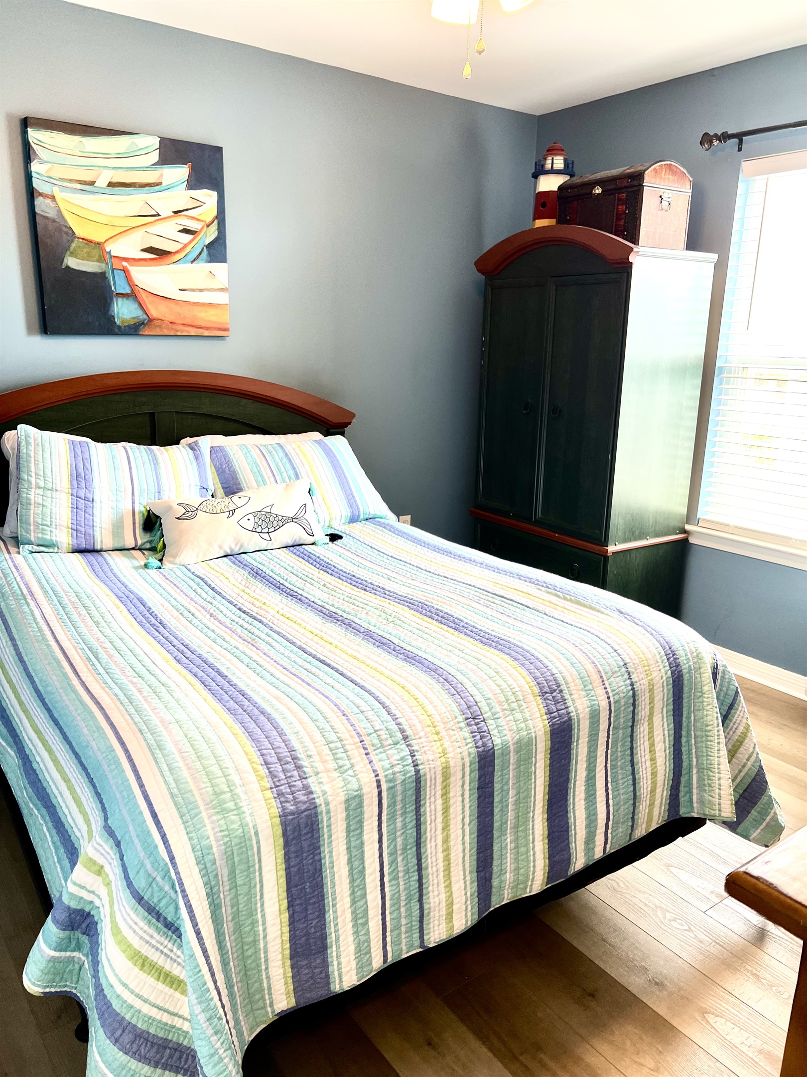 Queen bed in second bedroom with cotton linens and comforter on all beds