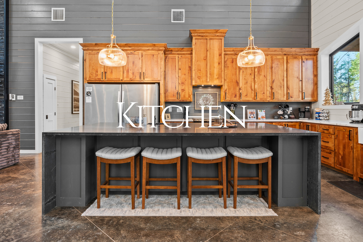 The spacious kitchen features a large island with plenty of seating, making it the perfect spot for everything from quick breakfasts to family dinners.