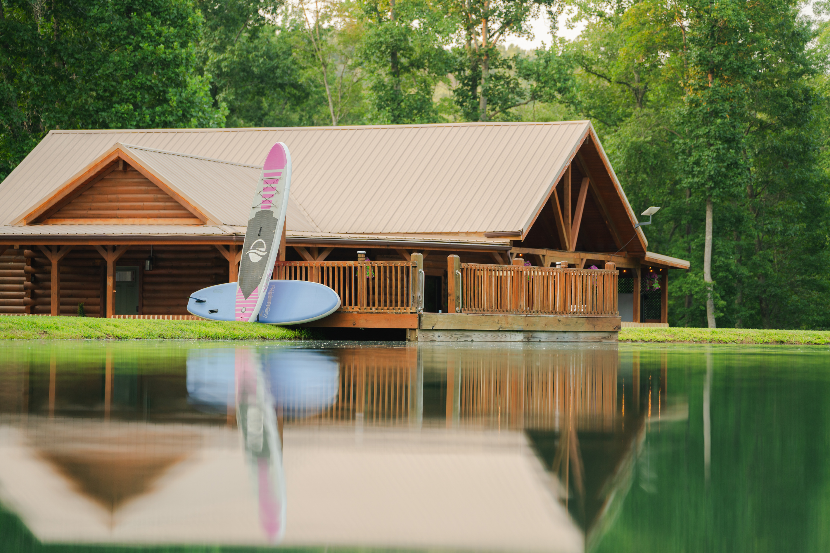 A peaceful pond framed by the cabin and surrounding woods, creating a beautiful backdrop for your getaway.