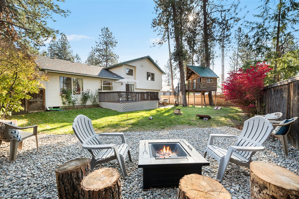 Backyard features bbq, 2 patios, treehouse, and wood fire pit for s'more making fun!