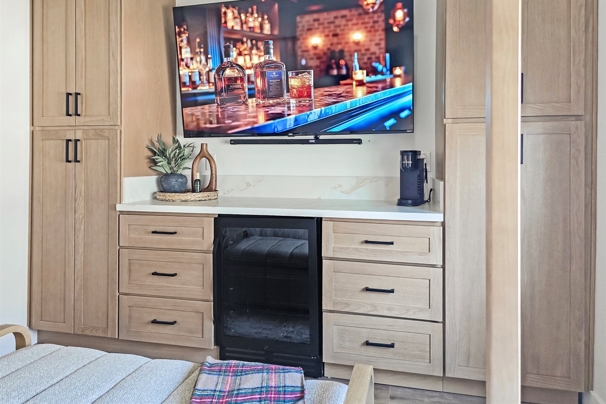 Beverage fridge, coffee maker and 75" smart tv with surround sound.