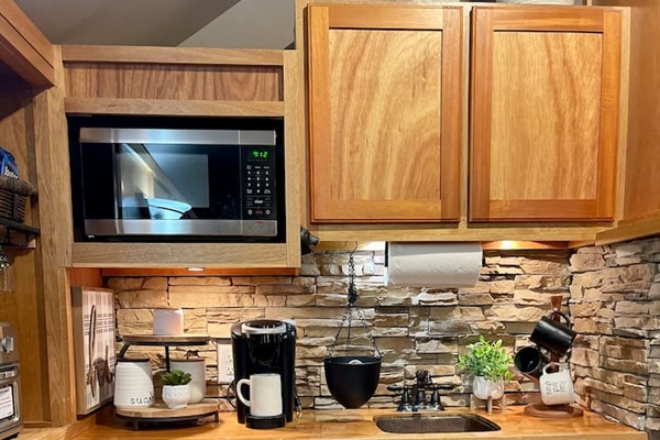 Kitchenette area includes small fridge, microwave, coffee station and cuisinart toaster/air fryer oven.  