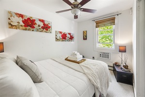 A different point of view of the queen bedroom starring a beautiful window
