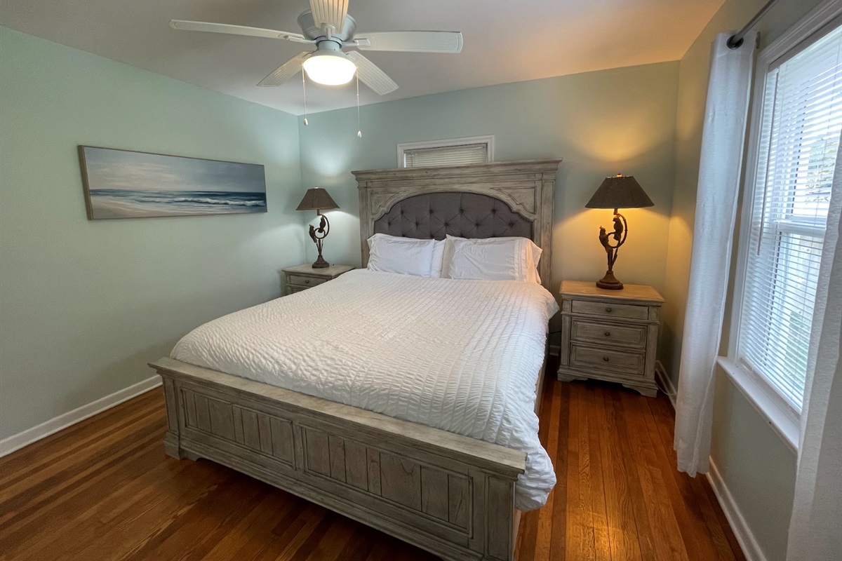 The first bedroom features a comfortable king-sized bed, facing the backyard. It also comes with an ensuite bathroom.