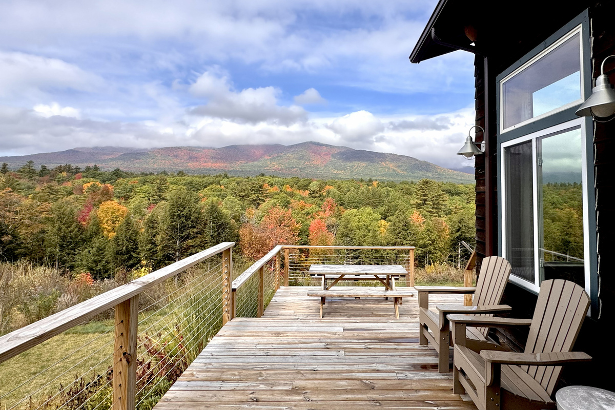 Relax on the spacious deck while taking in sweeping mountain and autumn foliage views.