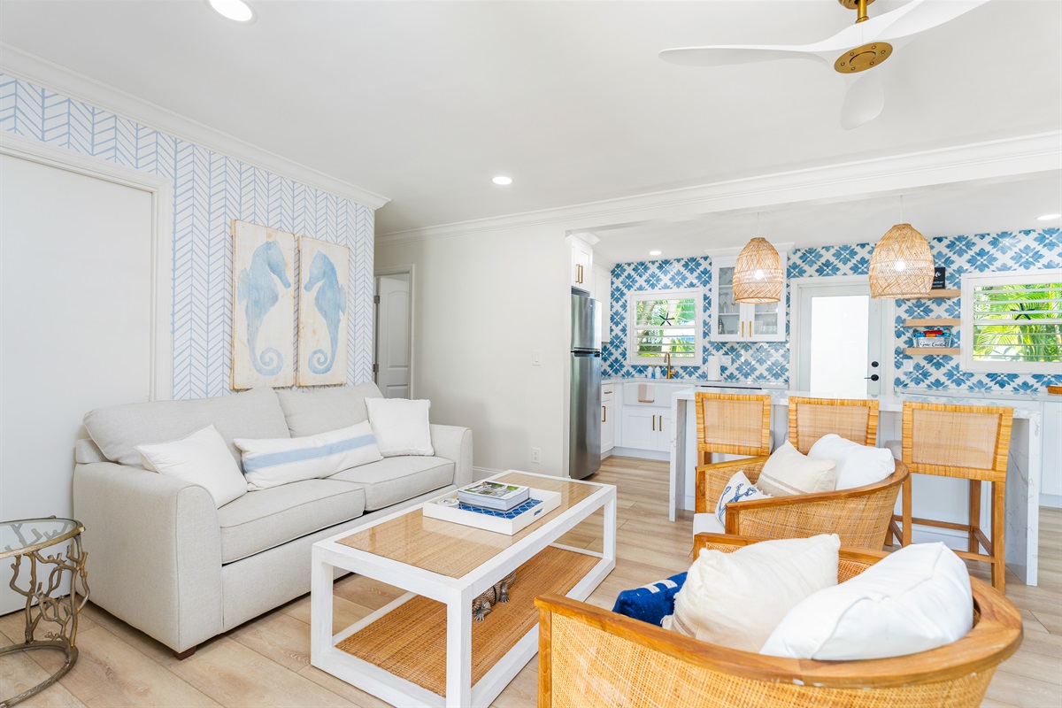 A cozy, well-designed living space highlighted by rattan seating and a bright breakfast bar that makes casual dining easy and inviting.