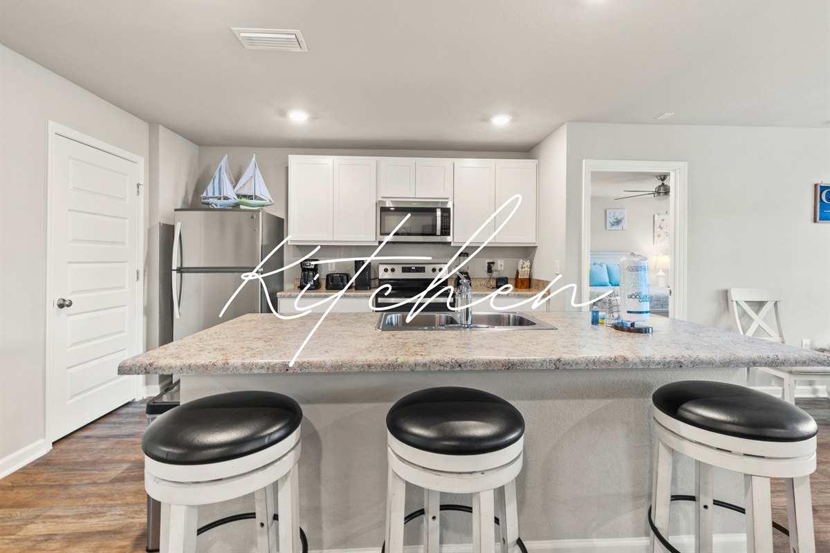Stylish kitchen island with bar seating for three, ideal for quick bites or chatting with the chef.