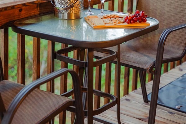 Enjoy a quiet moment at the outdoor dining table, surrounded by nature.