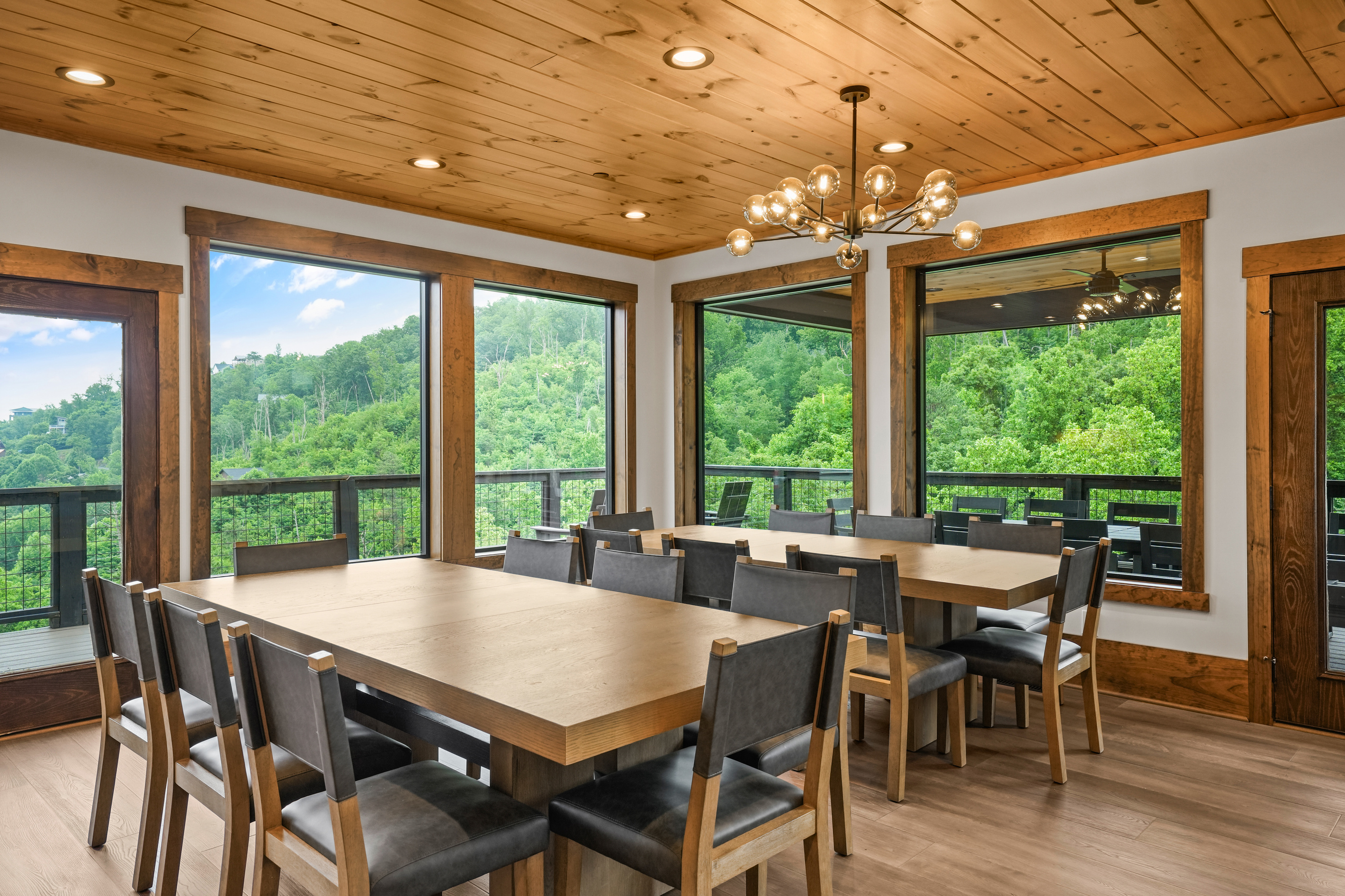 Enjoy unforgettable meals in a bright, open dining space featuring panoramic mountain views, elegant lighting, and plenty of room for your entire group to gather and connect.