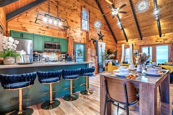 A warm and inviting dining space with family-style table and countertop seating, designed for comfort, connection, and enjoying the peaceful mountain ambiance.