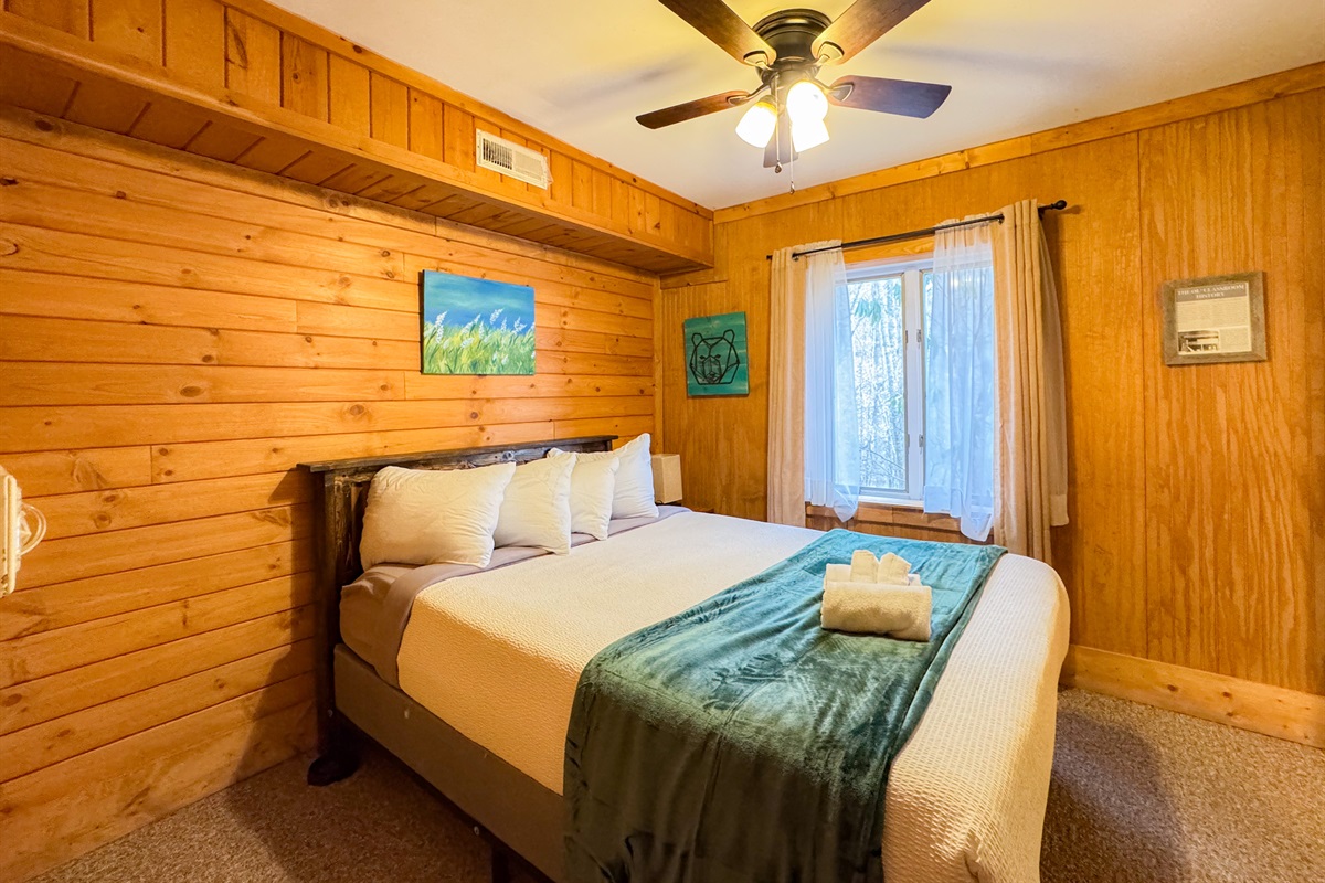 lower level bedroom featuring en-suite bathroom. Queen size hybrid memory foam bedc with shredded bamboo pillows