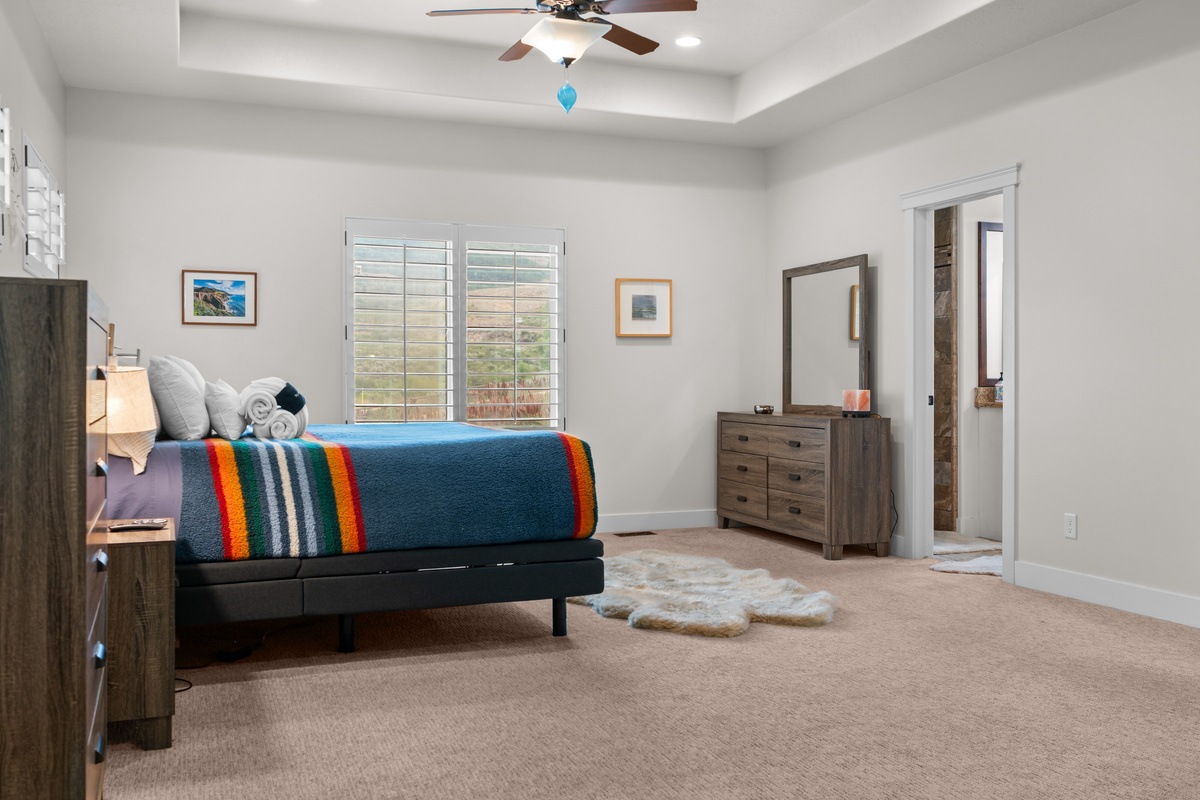 Your Private Sanctuary – The beautifully appointed primary bedroom combines comfort, elegance, and generous space for the perfect mountain getaway.