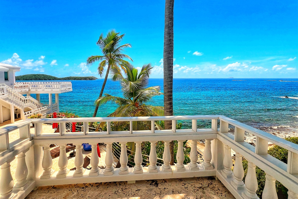Gaze across crystal waters from Bedroom's expansive balcony.