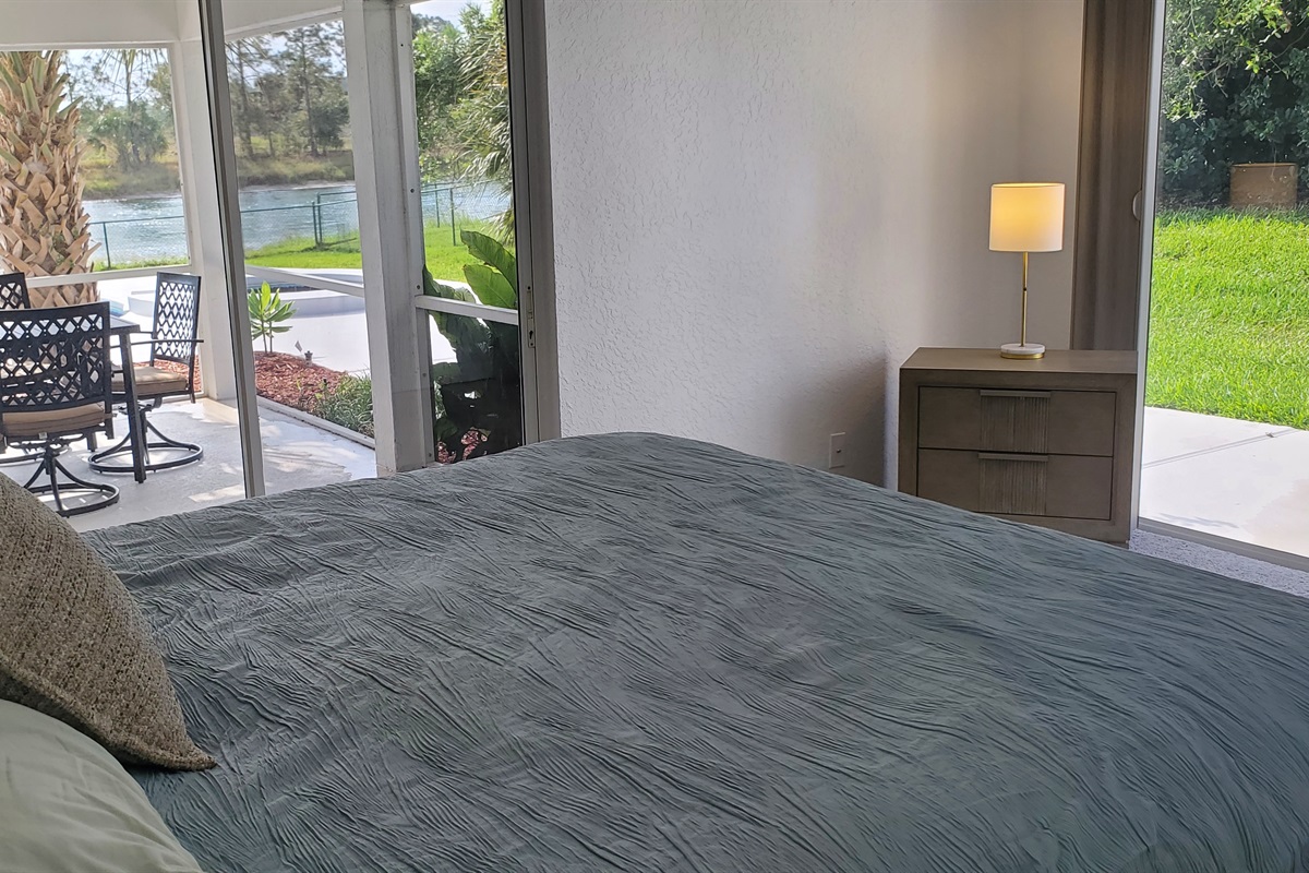 King bedroom with lanai and backyard access