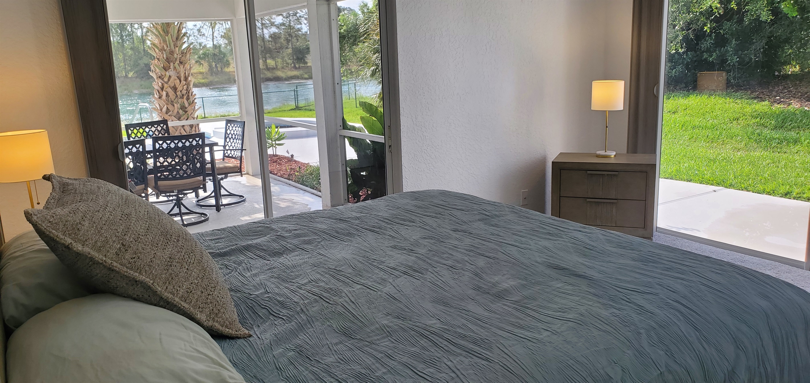 King bedroom with lanai and backyard access