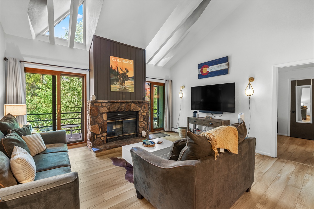 Living room with electric fireplace, 65" TV, private deck