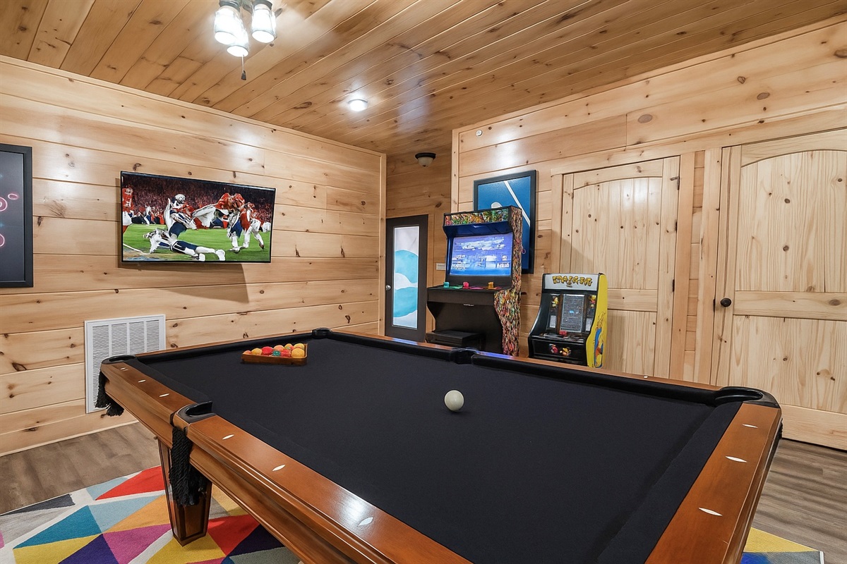 The game room also includes a pool table, 2 arcade games, and a TV