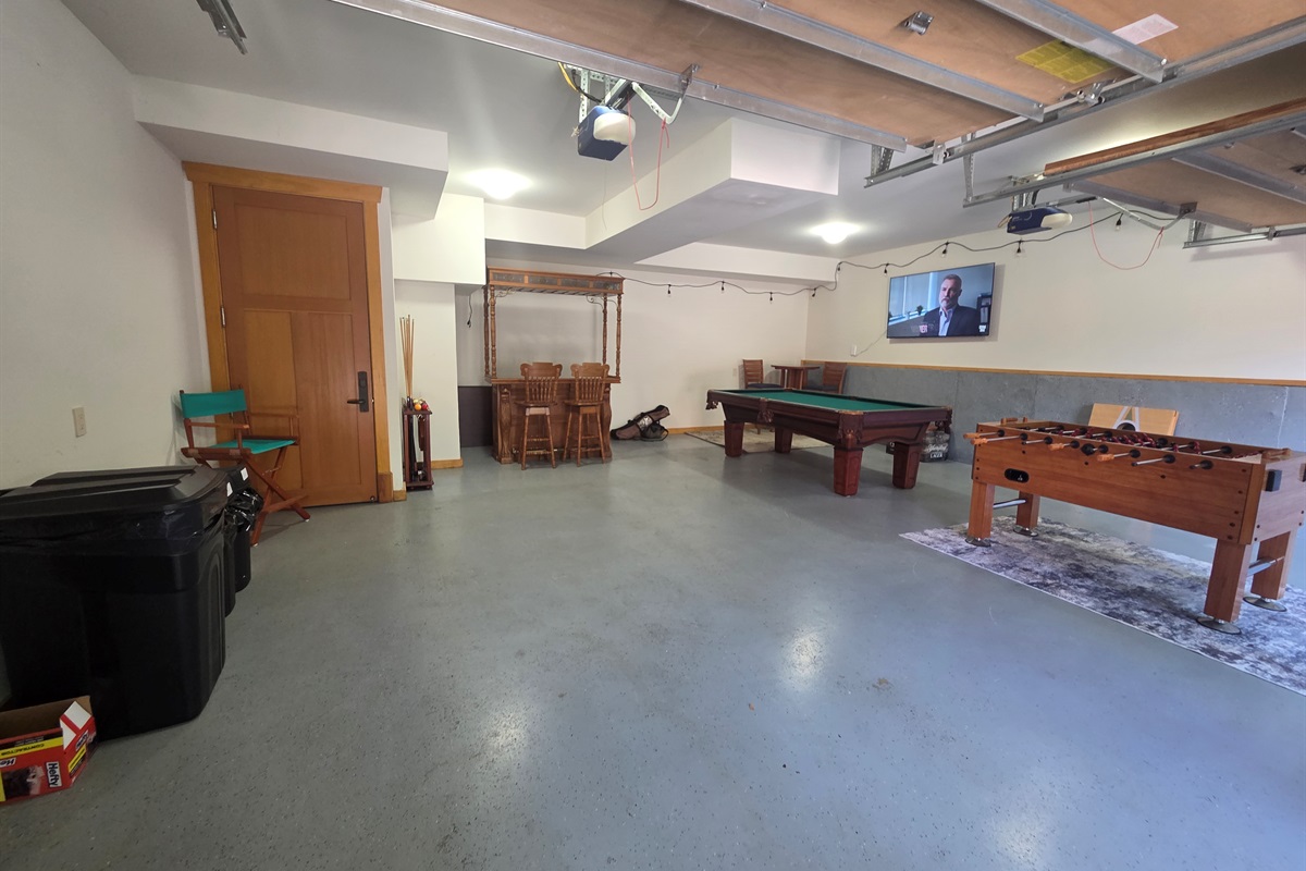 Enjoy friendly competition in the garage game room, complete with a pool table and foosball table