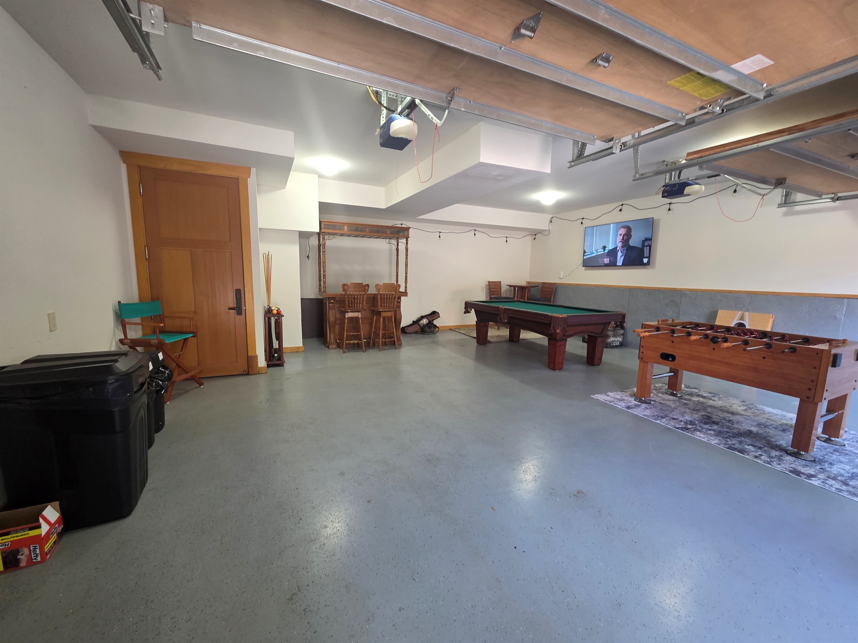 Enjoy friendly competition in the garage game room, complete with a pool table and foosball table
