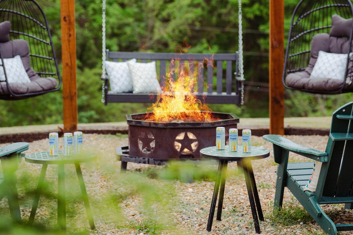The perfect night setup - firepit warmth, swinging seats