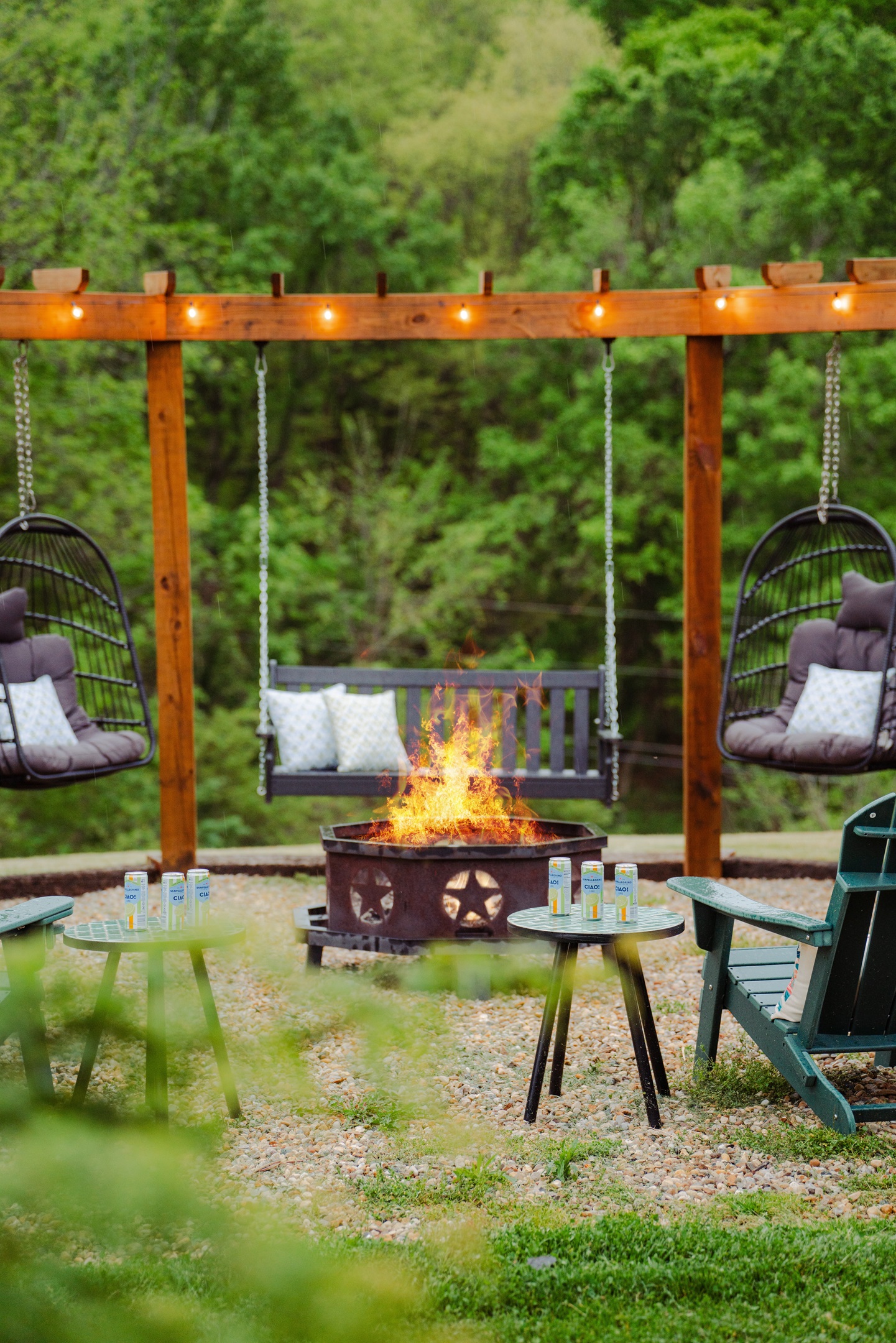 The perfect night setup - firepit warmth, swinging seats