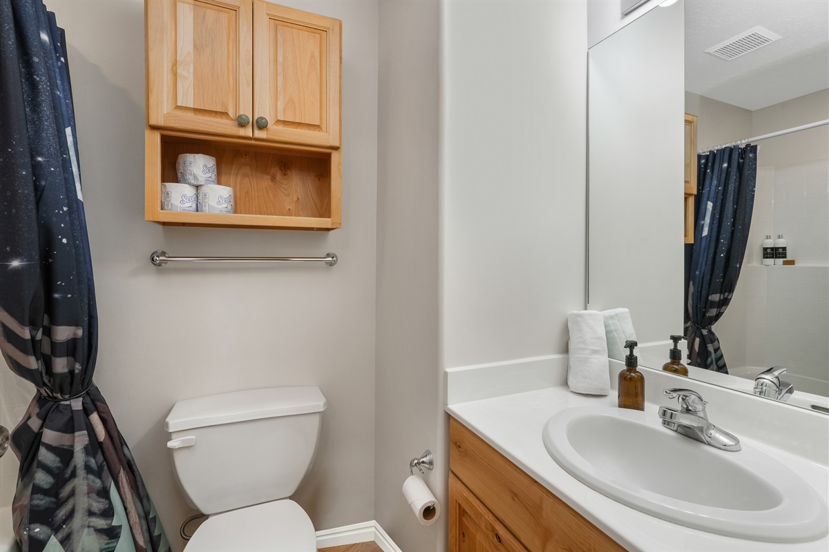 Lower-level bathroom with clean finishes and everything you need for your stay.