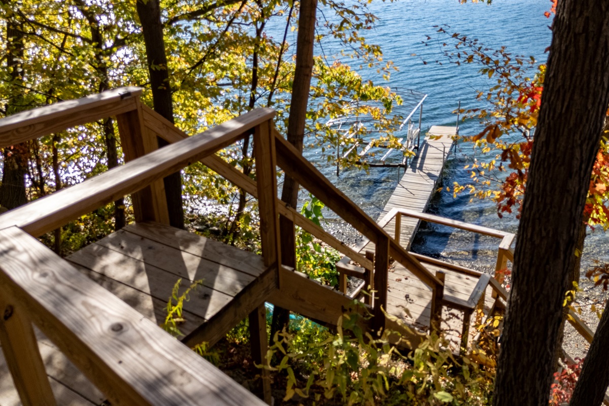 Wooden stair descent through trees to the lake’s edge — lakeside access.