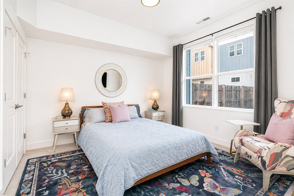 The ground-level Queen bedroom has its own ensuite bath, smart TV, and easy access to the backyard. It's setup as a private getaway from the rest of the house.