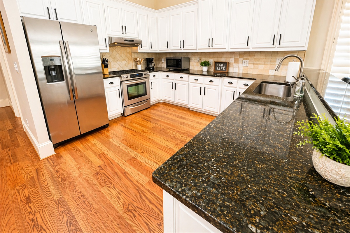 Cook, gather, and enjoy meals together in this open kitchen and dining space filled with natural light.