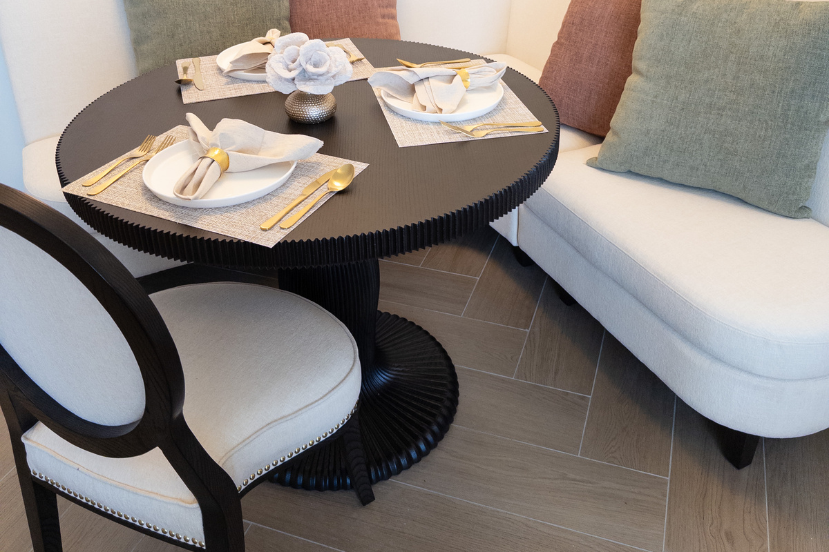 Den dining nook - a round bistro table for two beside the lounge.
