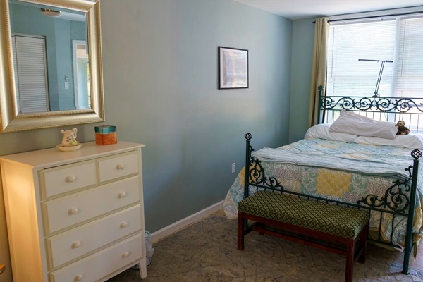 West bedroom, with closet space, chest of drawers, rocking chair & reading light, viscoelastic mattress with bedbug proof cover, & full length mirror. Extra pillows, blankets & sheets in the closet. 