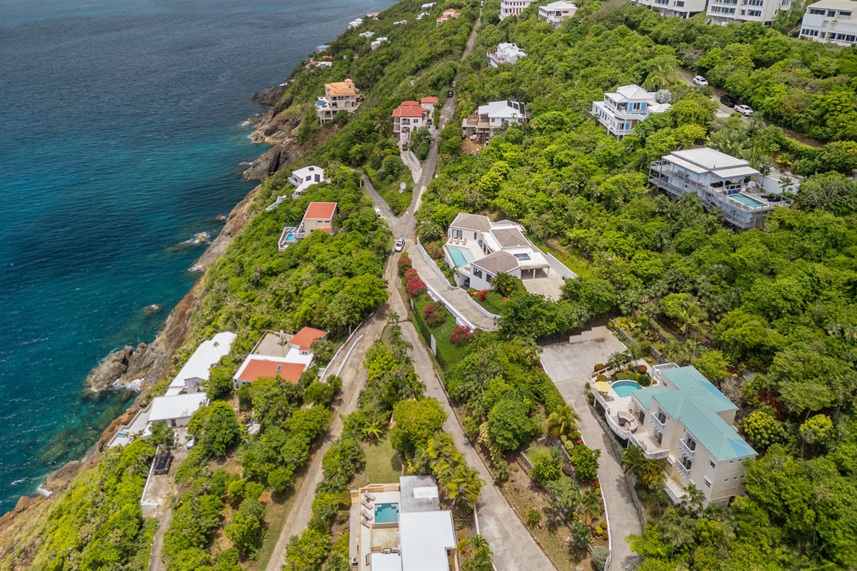 Charming island villa exterior with tropical plants and free parking. A beautiful welcome, every time.