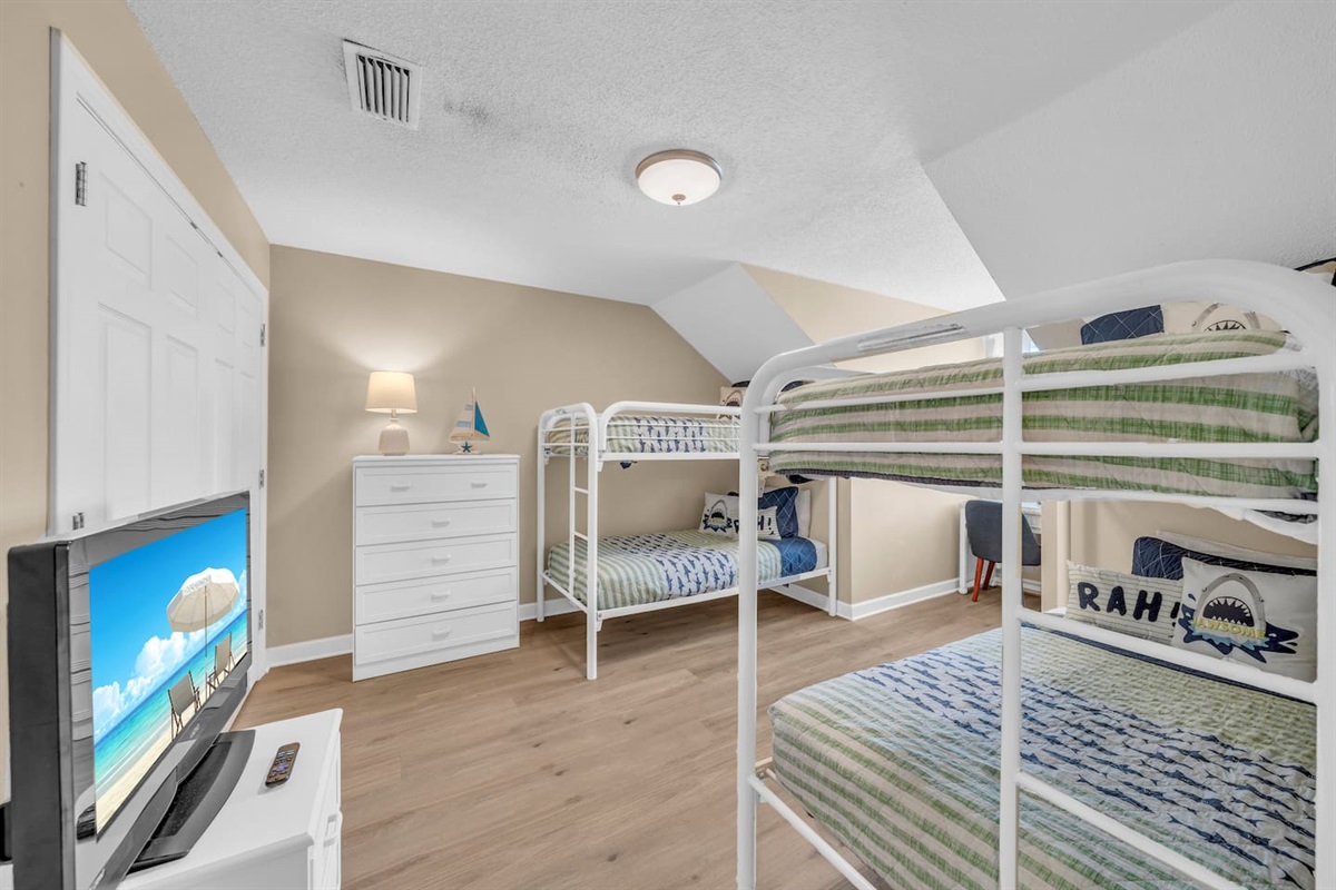 East upstairs bunk room.  Two sets of twin over twin bunkbeds, tv