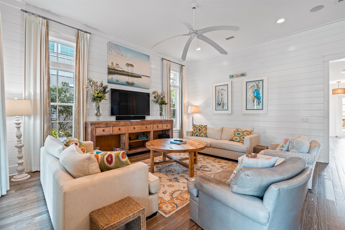 Beach vibes with shiplap walls and coastal decor in our light filled family room. 