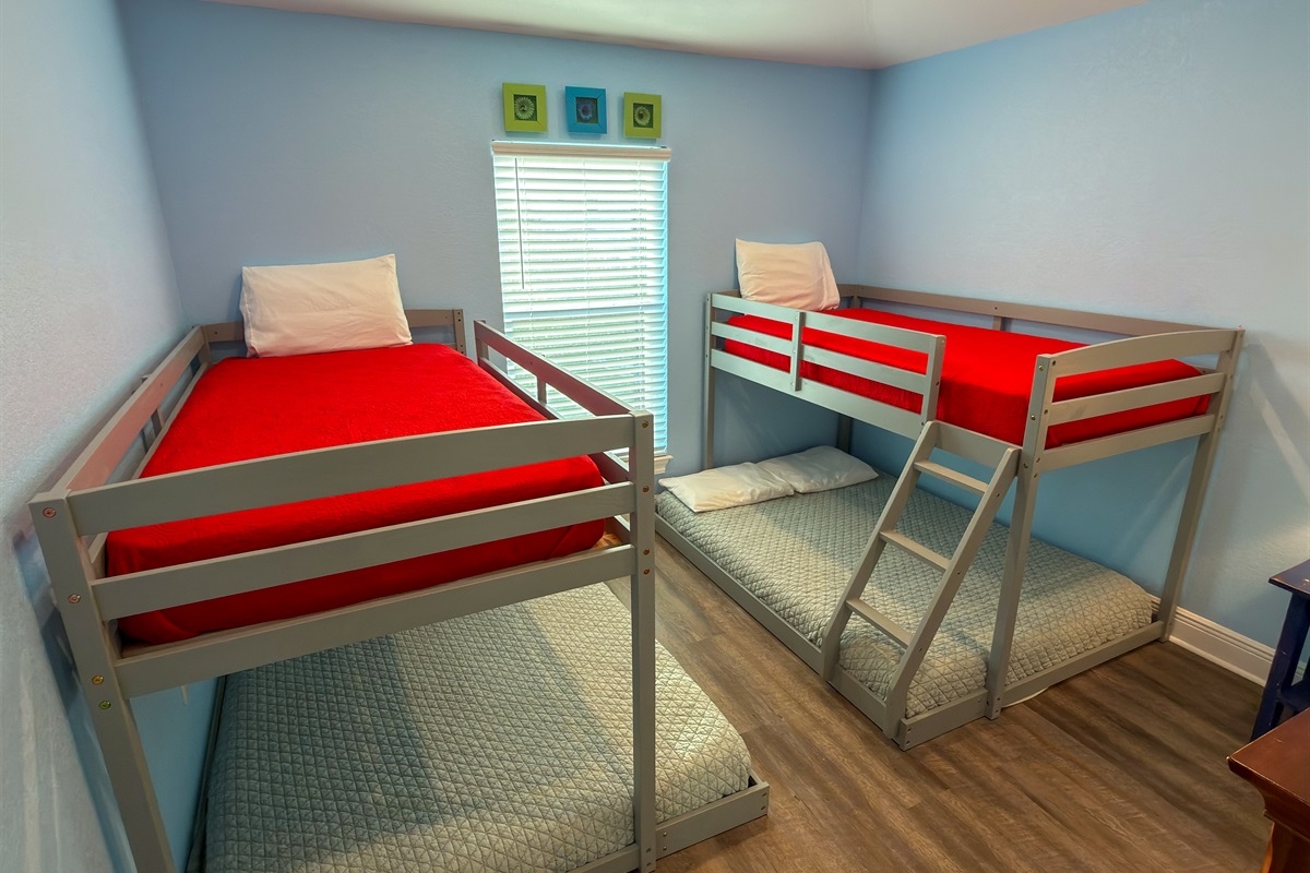 Second Floor Bunk Bedroom 4 is designed with younger guests and groups in mind, featuring two twin-over-full bunks in a bright and cheerful space.