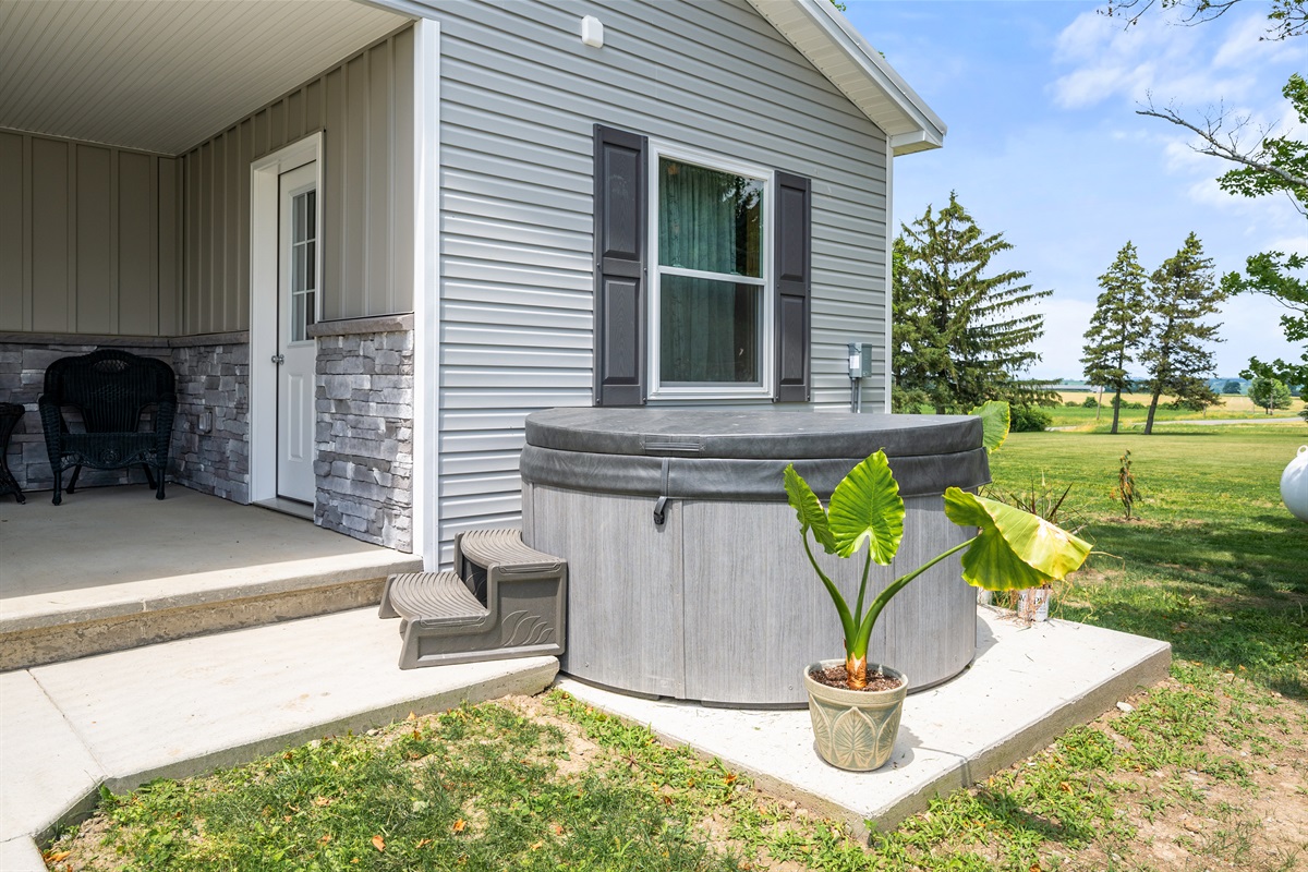 Private hot tub tucked beside the patio—your personal spot for stargazing and unwinding