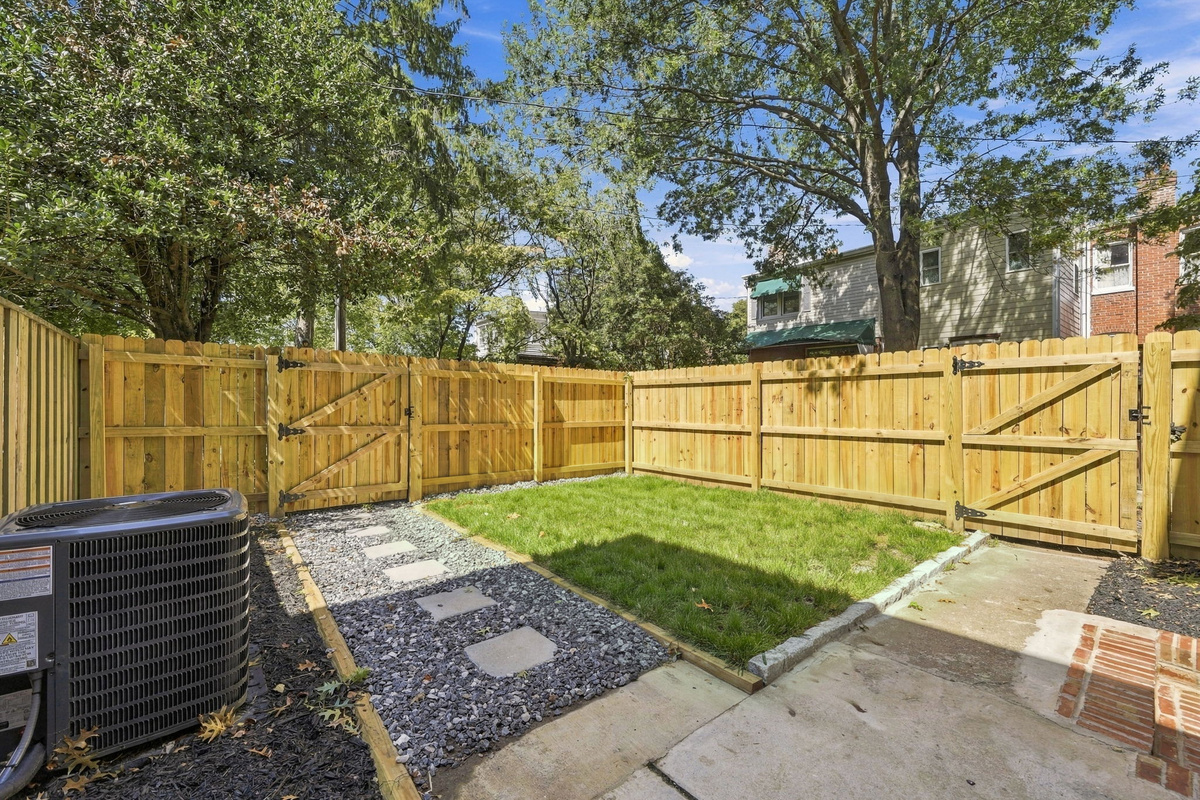 Private Oasis: Enjoy sunny afternoons in your fenced yard, complete with lush grass and a cozy path!