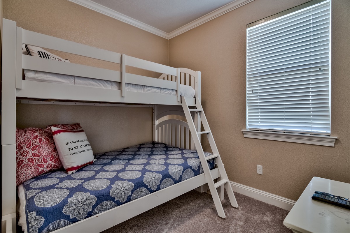 BEDROOM #6- 3RD FLOOR BUNK ROOM (Twin over Full bunk room, features a dresser and a TV)