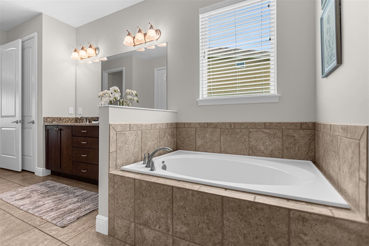 Chic bathroom highlighting a stylish bathtub and an inviting shower area, designed for comfort and rejuvenation in a serene atmosphere.