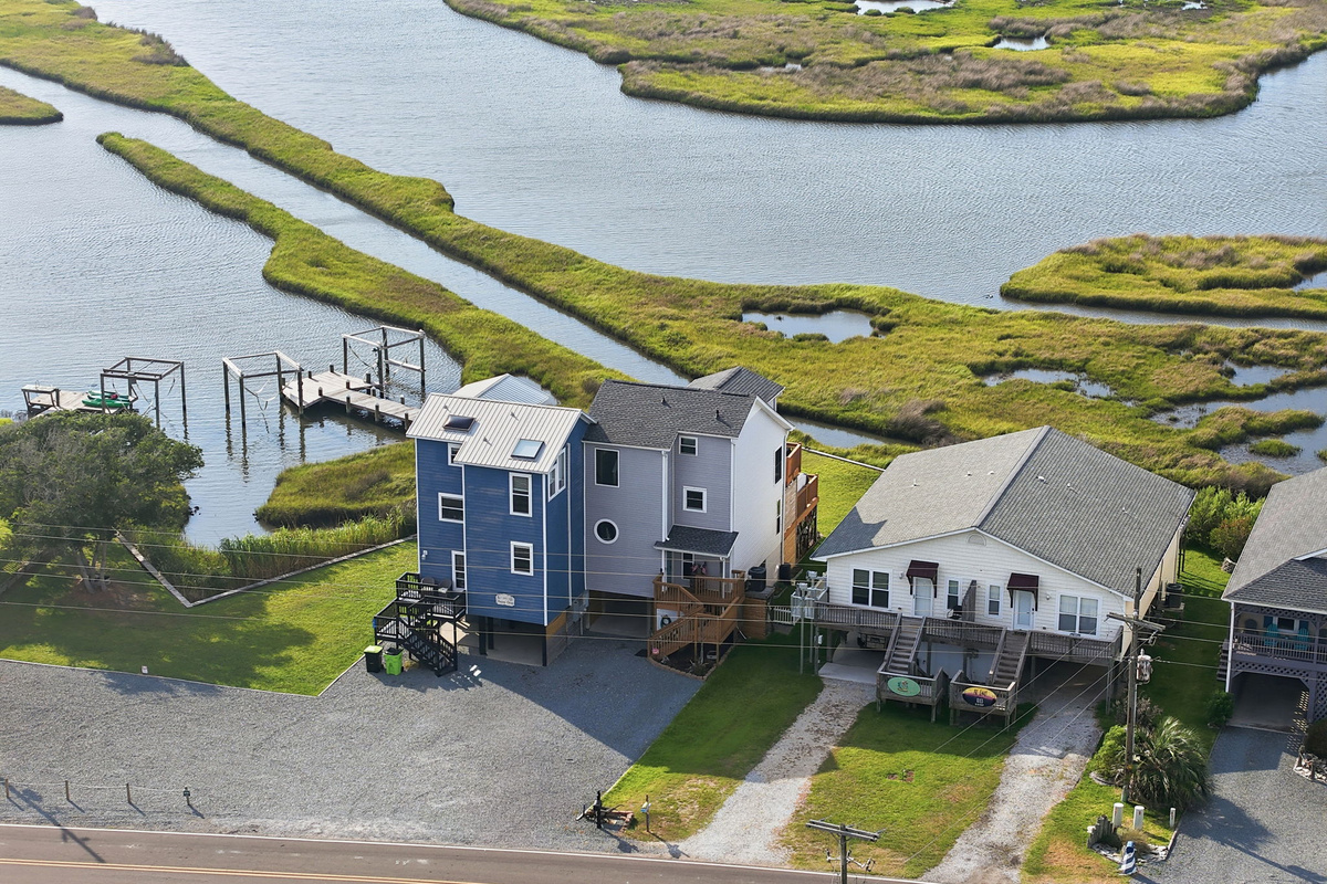 Aerial views showcase this beautiful retreat and its stunning soundside setting. 