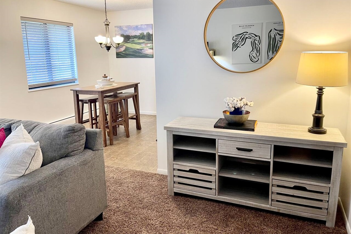 This charming space features a cozy dining nook and stylish console area with warm lighting and tasteful decor. Ideal for enjoying quiet meals or evening conversations, it blends comfort and functionality in a welcoming home-away-from-home atmosphere
