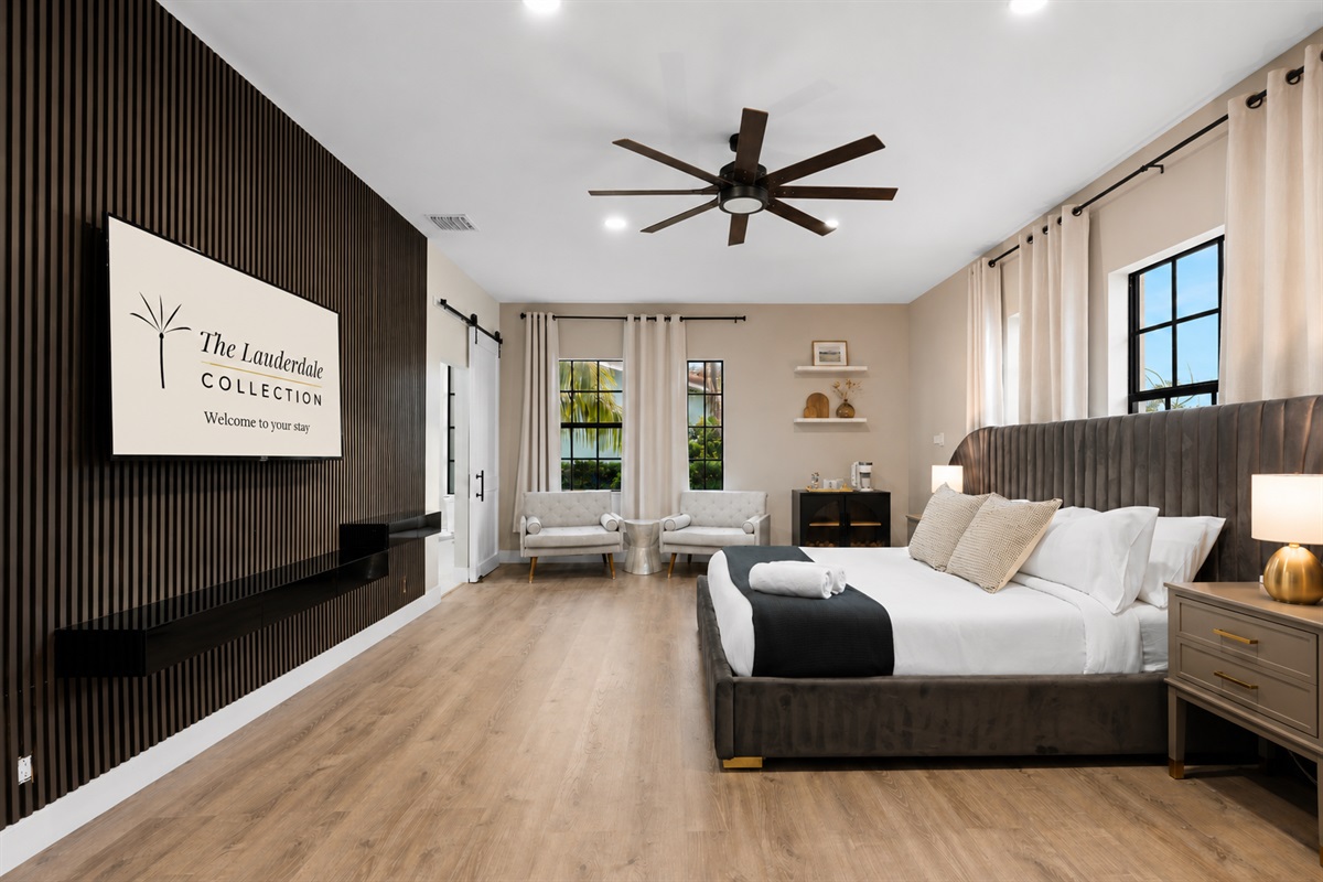 🛌 Downstairs master suite with 65" TV, cozy chairs, and your own coffee station to start off each day.