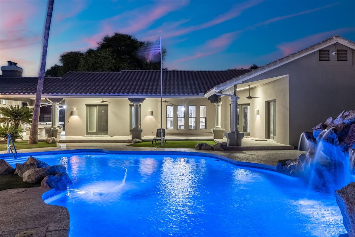Whether day or night, this beautifully designed pool and covered patio offer the perfect private oasis.

