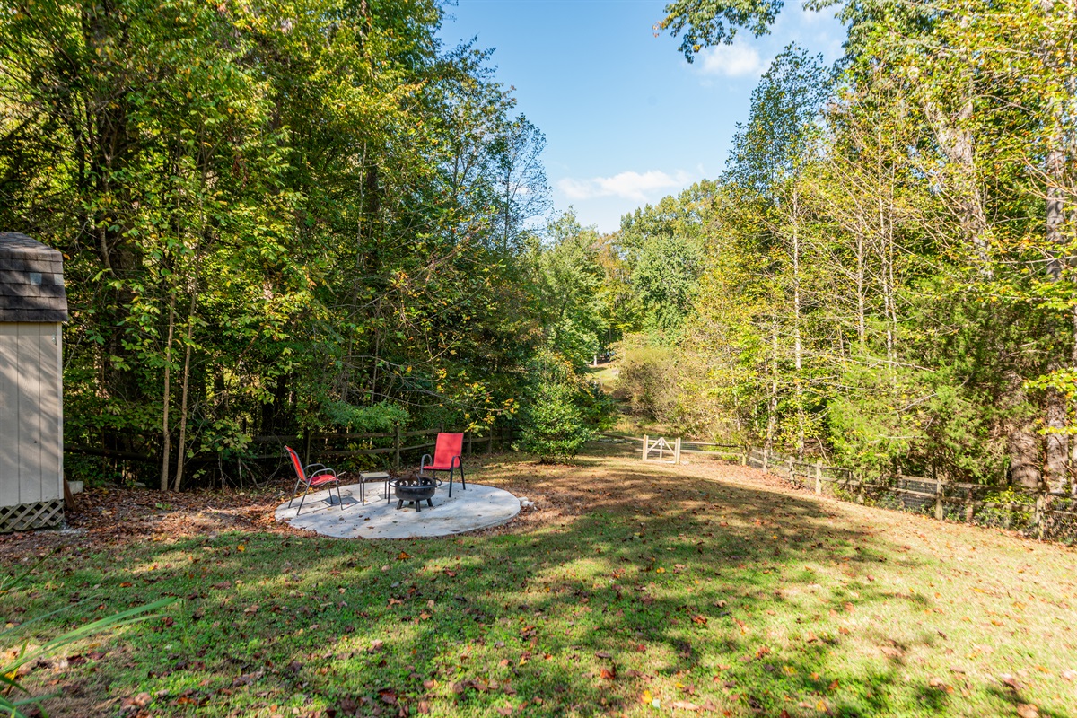 Outdoor Relaxation Spot: Enjoy fireside chats surrounded by tranquil woods and nature's beauty!