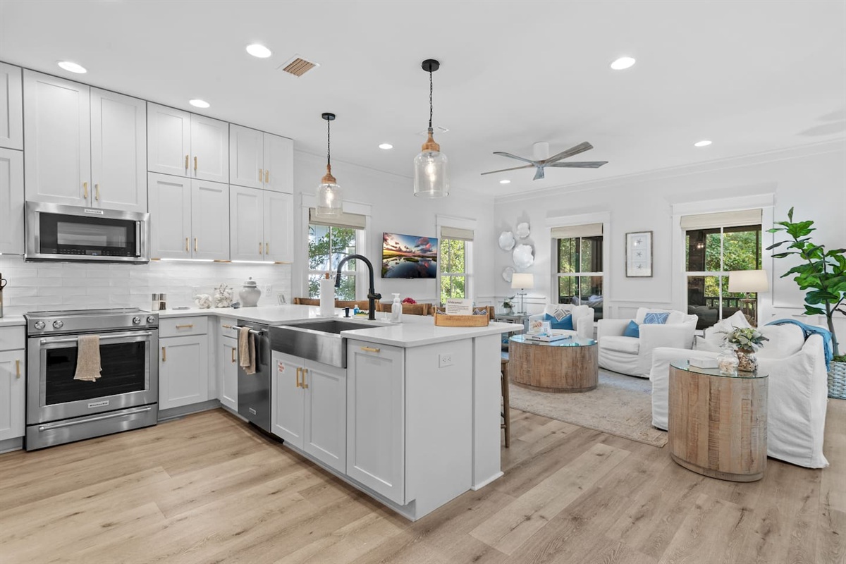 Fully stocked kitchen with KitchenAid appliances, stove, oven, microwave, dishwasher, farmhouse sink and garbage disposal.