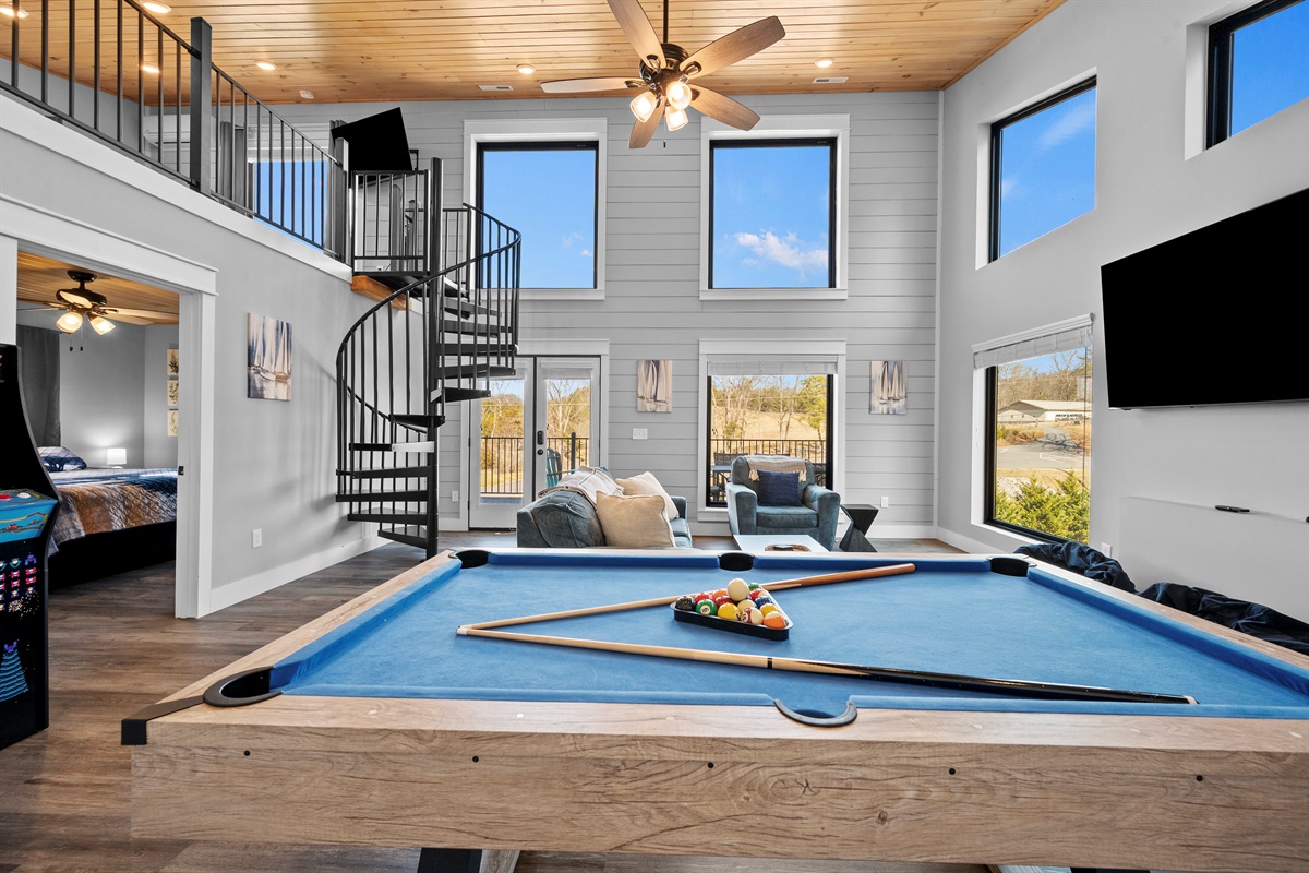 Another angle of the game room showcasing the open layout, natural light, and connection to the rest of the home.
