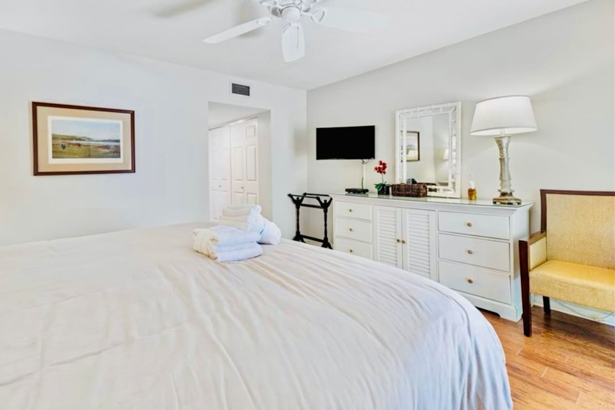 Primary bedroom with dresser and Smart TV