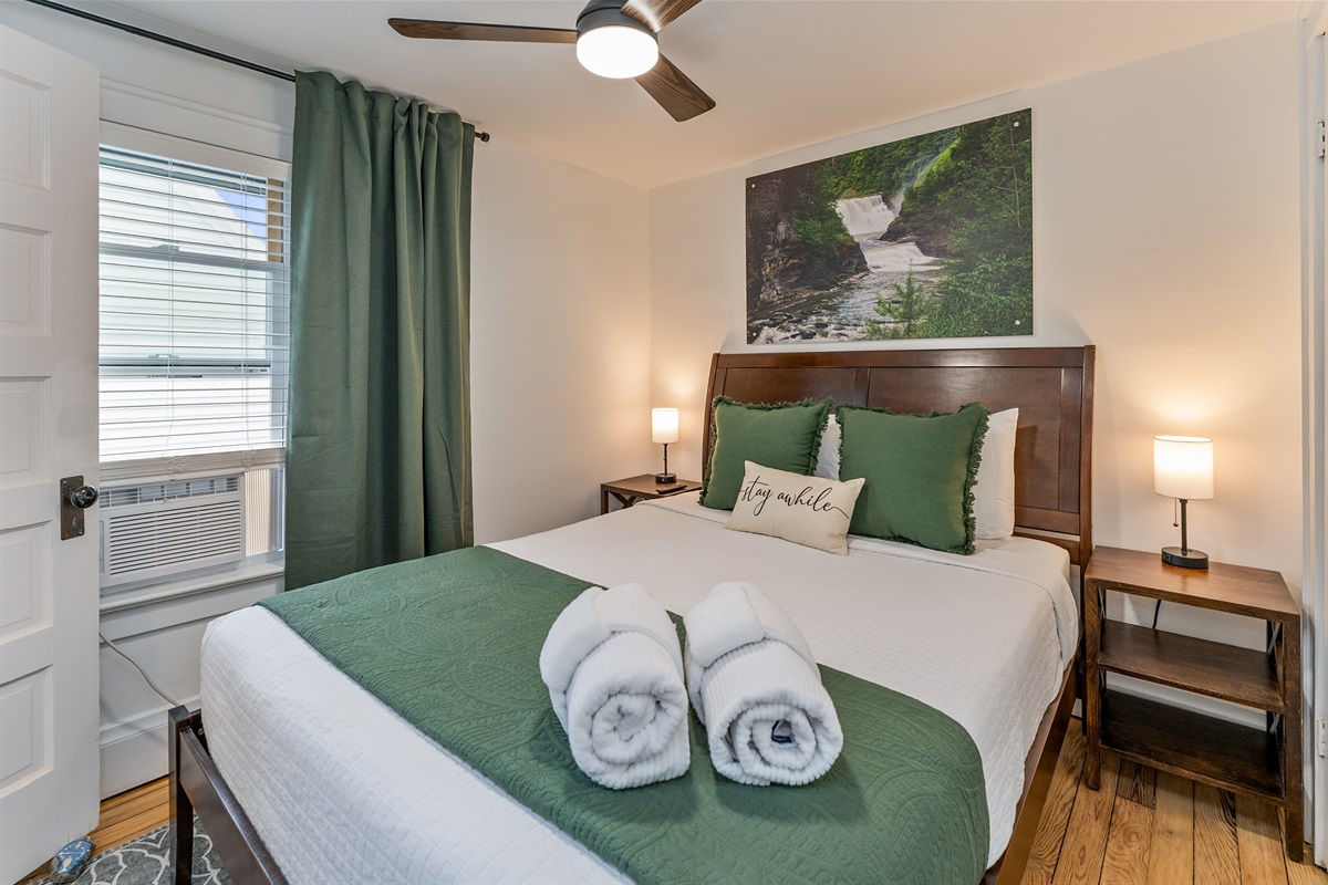 Tranquil queen bedroom retreat with nature-inspired decor, plush bedding, and soothing green accents—unwind and stay awhile! Bedroom #3